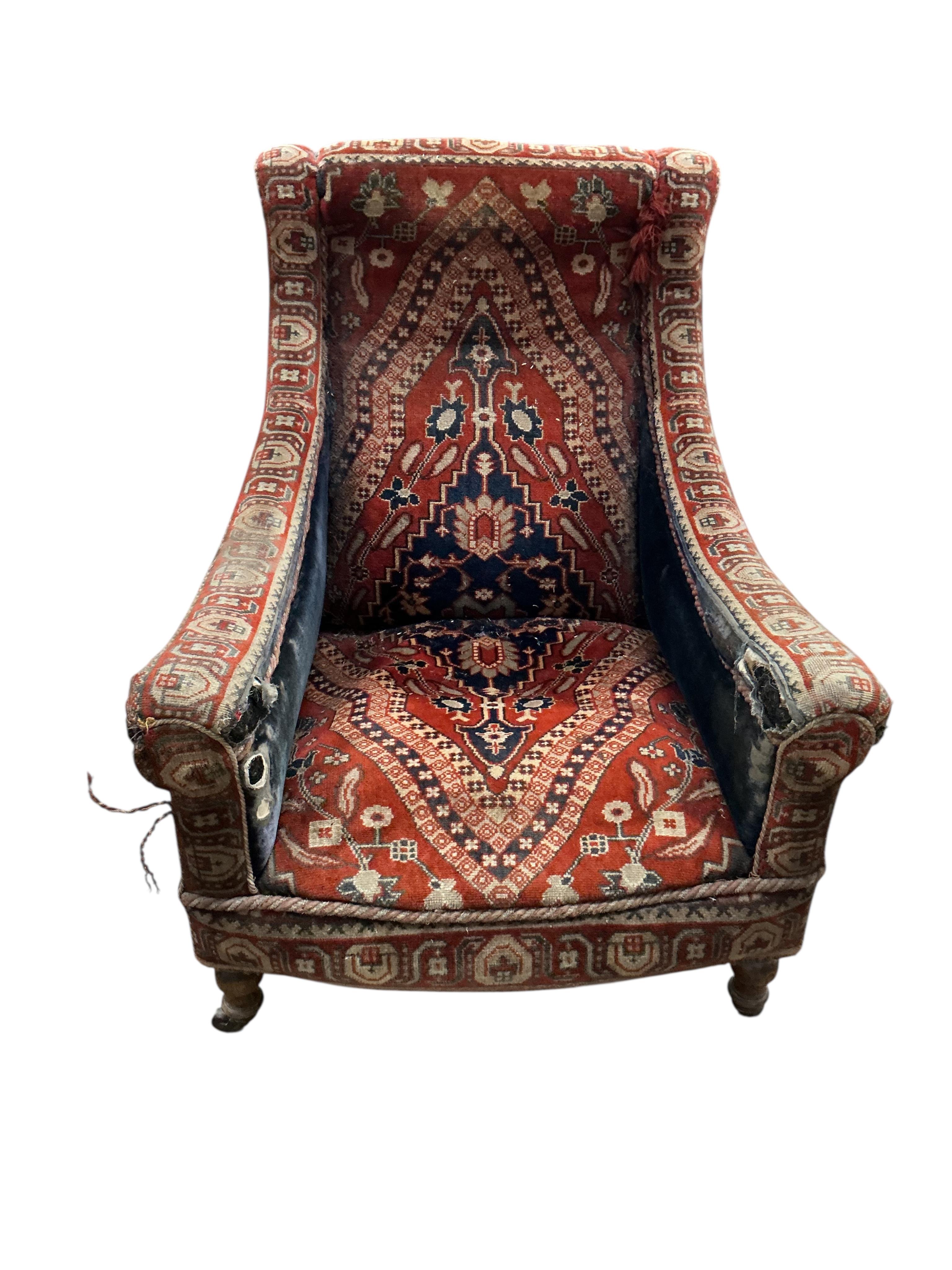 A Victorian carpet upholstered armchair, width 76cm, depth 78cm, height 90cm, Provenance: The late Kenneth Turner (1936-2025), celebrity florist, designer and perfume retailer, he received the Royal Warrant from the Prin